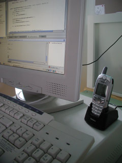 The receiving cell phone connected to a PC running the custom Java application.